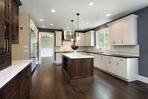 Classic white and brown kitchen with hardwood dark brown flooring