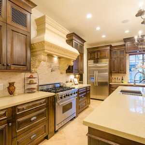 lovely kitchen with brown cabinets and brown island