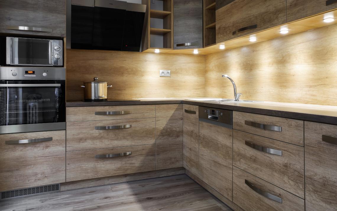 Bright hazel cabinets with light hardwood flooring