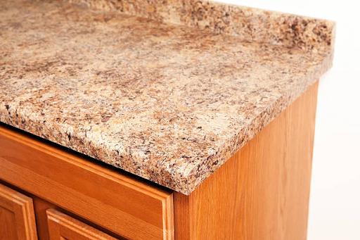 A granite countertop installed on an oak kitchen cabinet.