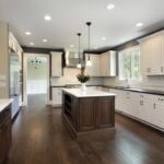 Classic white and brown kitchen with hardwood dark brown flooring