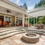 Photo Showing deck patio space with a white dining pergola