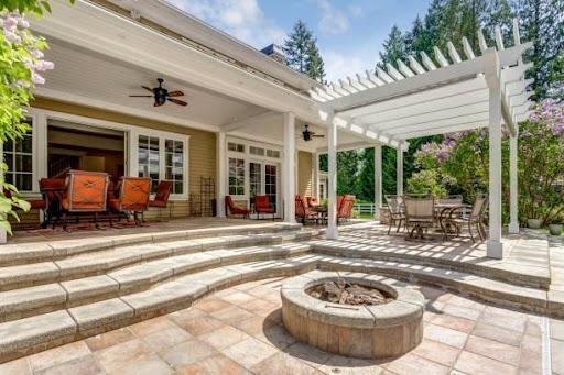Photo Showing deck patio space with a white dining pergola